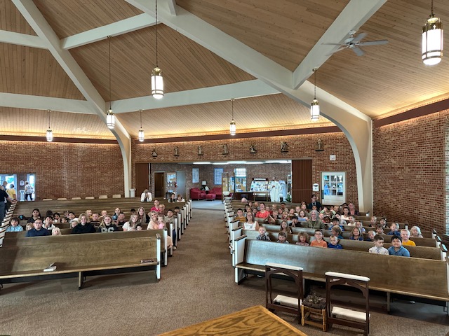 St. Mary students, teachers and families fill the church pews for First Mass